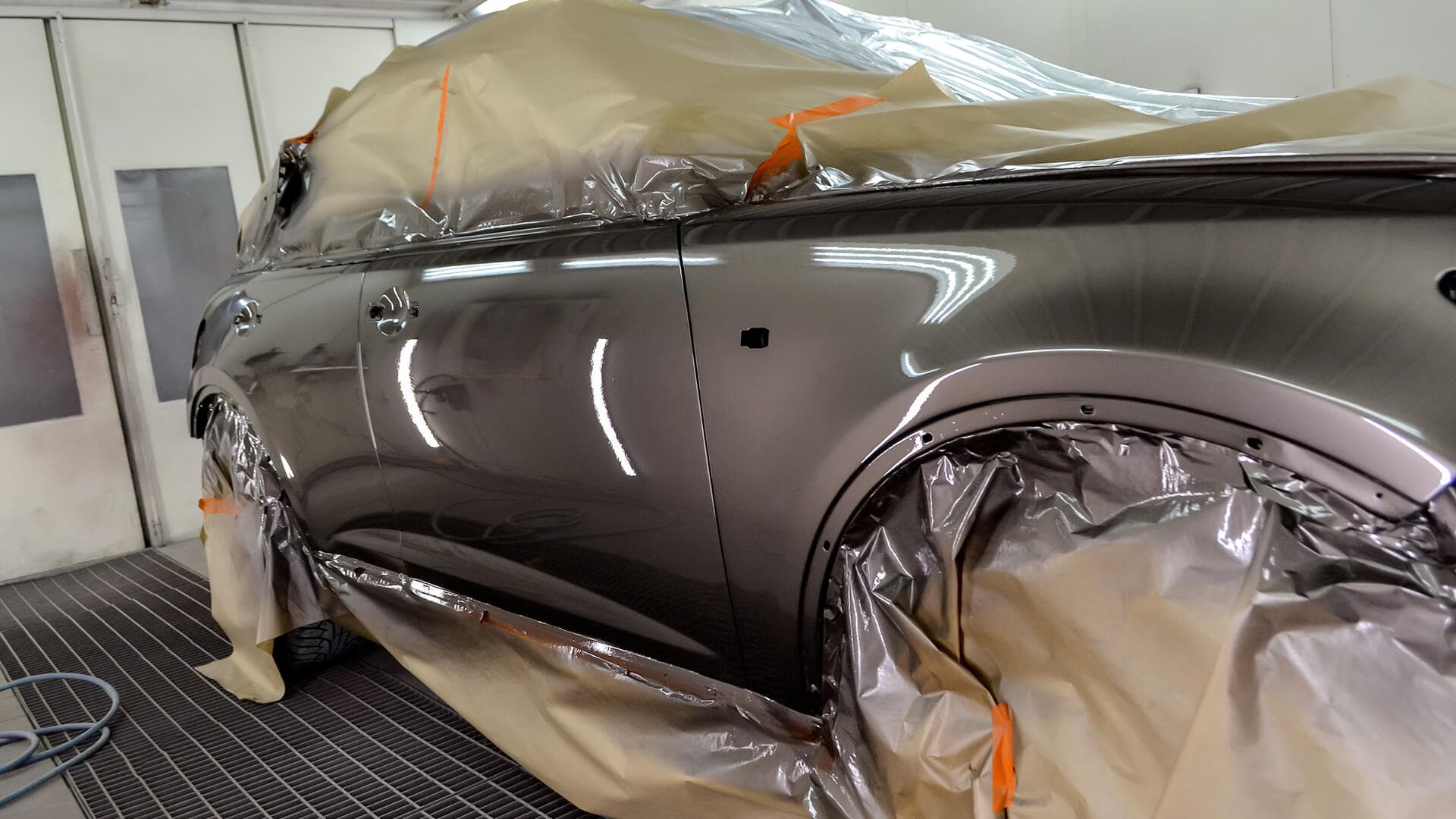 Technician painting a car
